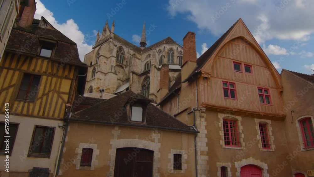 View of a beautiful street with old traditional French houses in the center of Auxerre with clouds in the background. Legacy of French history. Historic hotels, colorful houses in France. Time Lapse View of a beautiful street with old traditional French houses in the center of Auxerre with clouds in the background. Legacy of French history. Historic hotels, colorful houses in France. Time Lapse