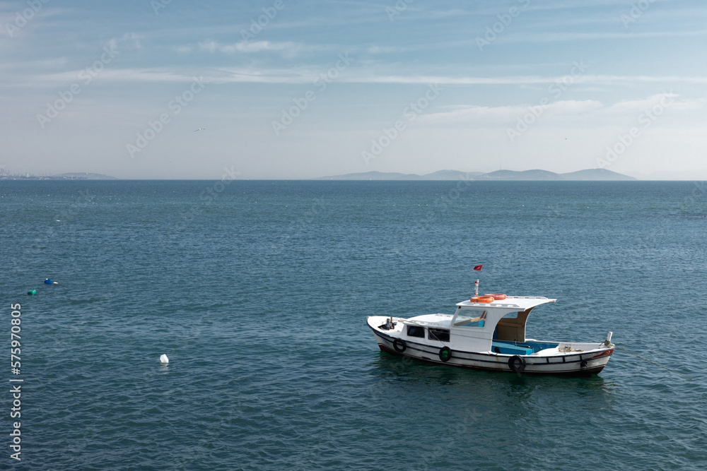 A small boat is anchored in the sea.