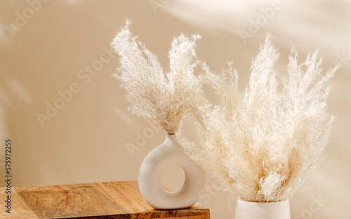 Vase set with pampas grass and copy space with wooden platform for home product presentation. Empty wooden podium, Scandinavian interior style