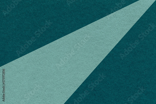 Texture of old craft cyan and dark emerald color paper background, macro. Vintage abstract teal cardboard
