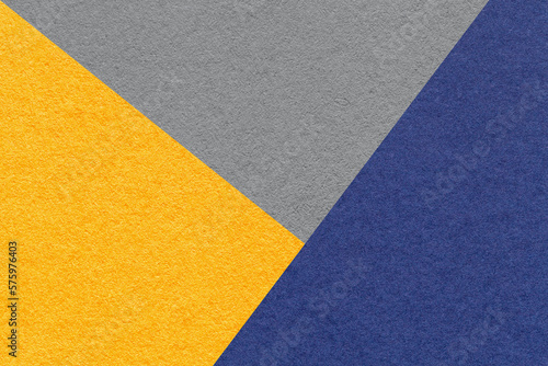 Texture of craft yellow, gray and navy blue shade color paper background, macro. Structure of vintage abstract cardboard