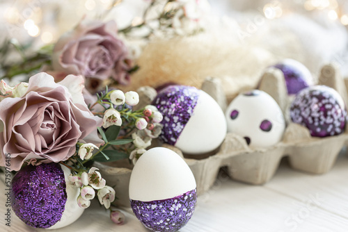 Easter composition with decorative eggs and flowers, close-up.