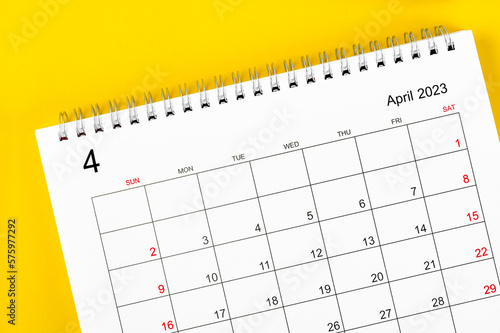 The April 2023 Monthly desk calendar for 2023 year on yellow color background. © gamjai