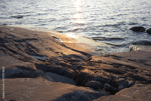 Evening sun coloring the smooth rock in the archipelago in summer