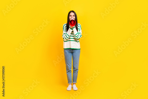 Full length photo of astonished excited positive lady wear stylish striped clothes share special offer isolated on yellow color background