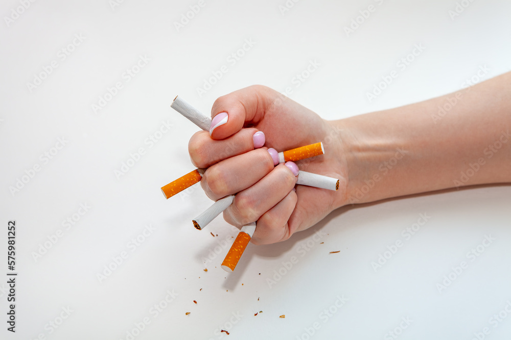 The broken cigarette on hand. Winning with addicted nicotine problems, stop smoking The broken cigarette on hand. Winning with addicted nicotine problems, stop smoking