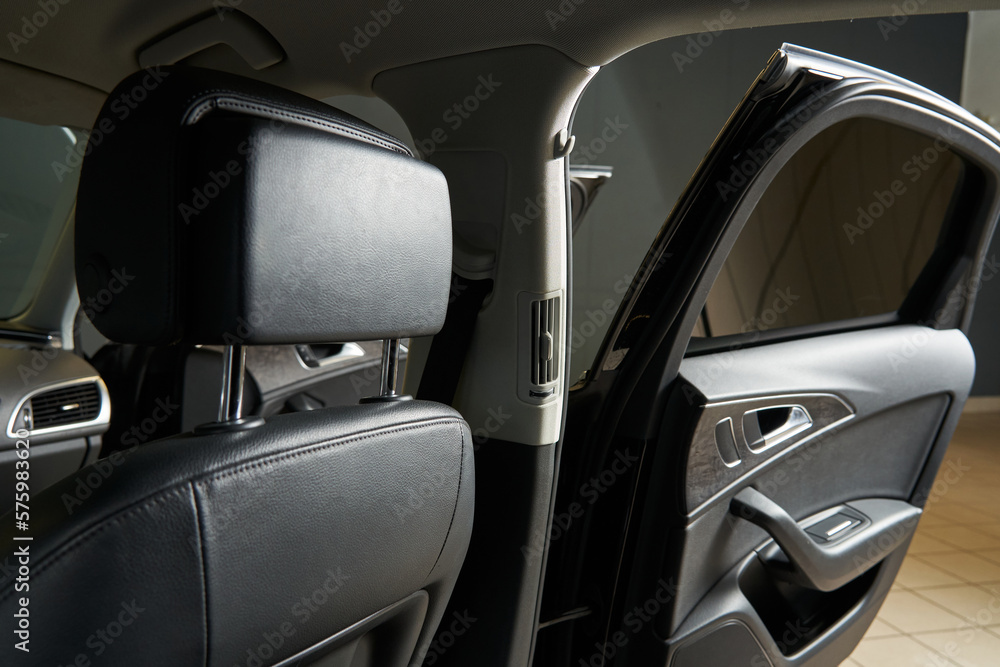 open doors of the leather interior of the car. headrest, opening handles, deflectors