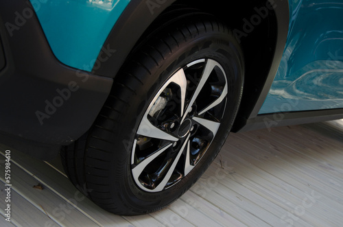 car cover  rubber and new car tire. blue brand car