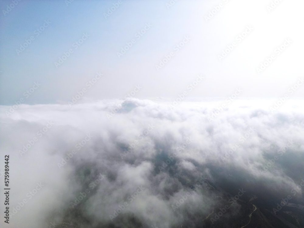 Flying above the clouds on drone.Drone soars through thick clouds, revealing majestic mountain silhouettes. Calp, Alicante, Spain