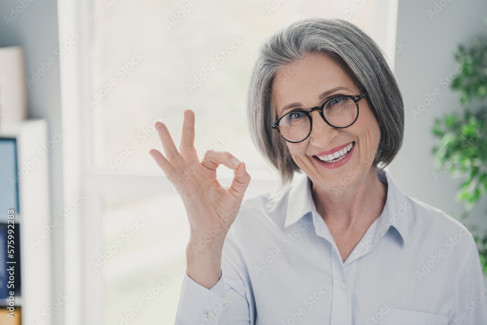 Photo of cheerful experienced attorney lady toothy smile arm fingers demonstrate okey symbol bright day office workplace indoors Photo of cheerful experienced attorney lady toothy smile arm fingers demonstrate okey symbol bright day office workplace indoors