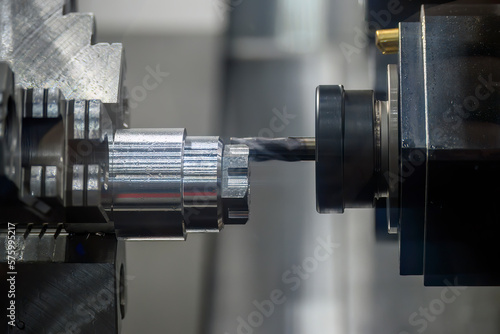 The multi-tasking CNC lathe machine  milling cut the metal shaft parts by milling turret.