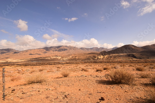 Mountain landscape with a sandy strip on a sunny day