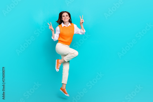 Full body cadre photo of young successful woman influencer office worker showing v-sign jump peace everyone isolated on cyan color background