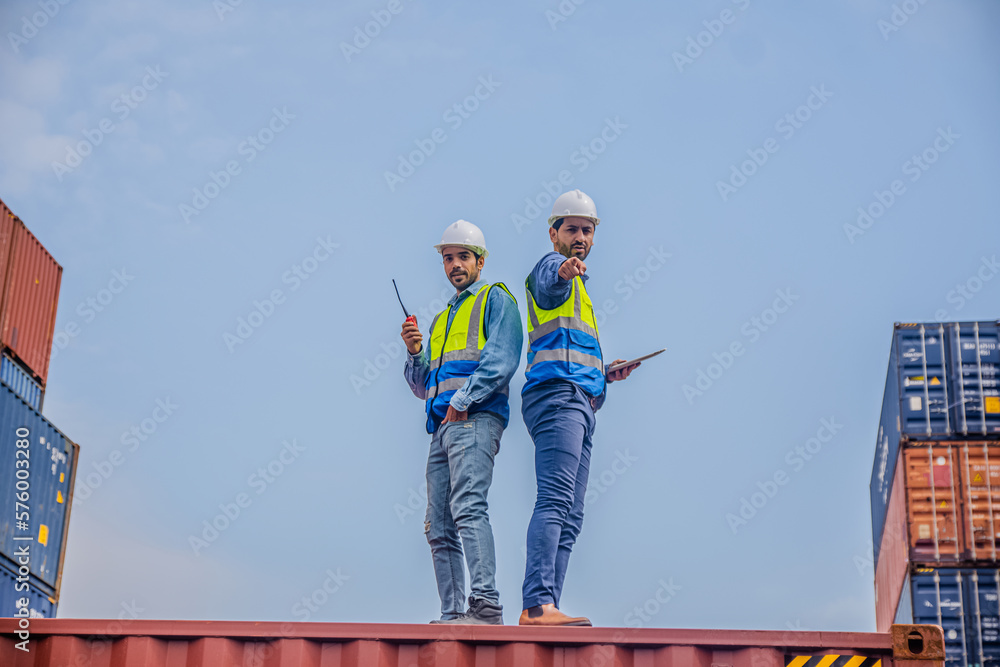 Team Engineers are inspecting the transportation of cargo with containers inside the warehouse. Container in export and import business and logistics. Team Engineers are inspecting the transportation of cargo with containers inside the warehouse. Container in export and import business and logistics.