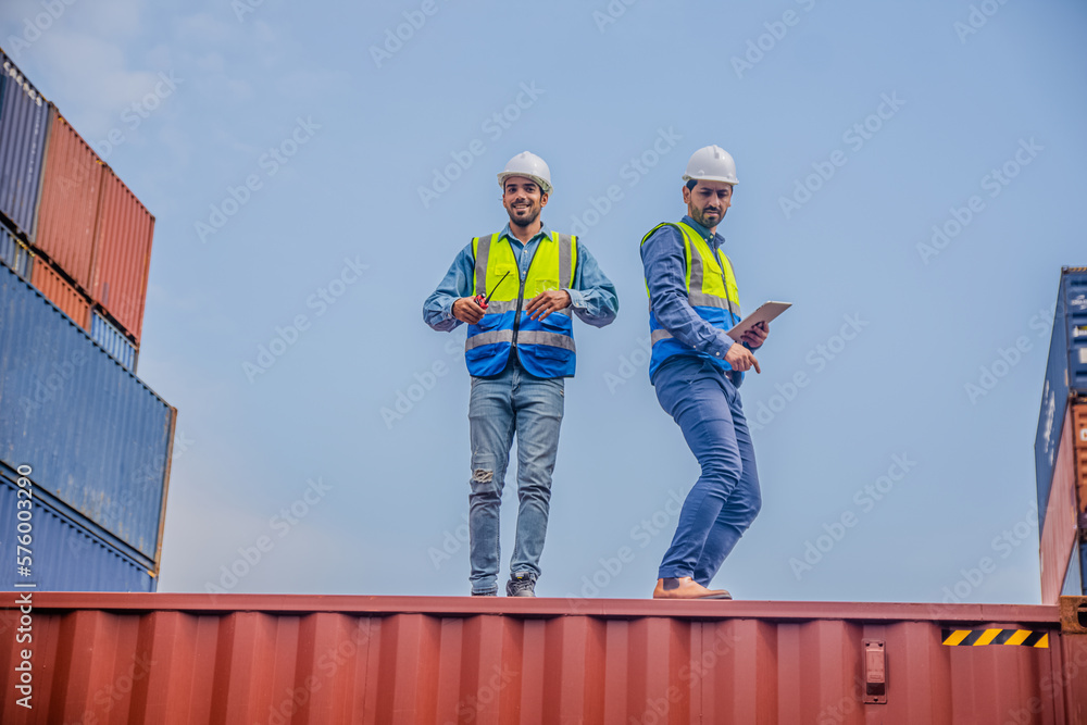 Obraz premium Team Engineers are inspecting the transportation of cargo with containers inside the warehouse. Container in export and import business and logistics.