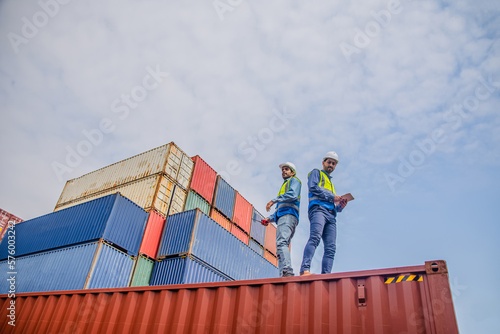 Team Engineers are inspecting the transportation of cargo with containers inside the warehouse. Container in export and import business and logistics.