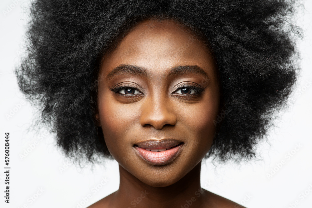African Woman close up Portrait over White. Dark Skinned Beauty Model with Afro Hairstyle and Natural Makeup. Women Face Skin Care and Cosmetology African Woman close up Portrait over White. Dark Skinned Beauty Model with Afro Hairstyle and Natural Makeup. Women Face Skin Care and Cosmetology