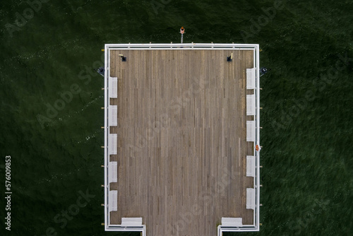 wooden pier on the background of green water