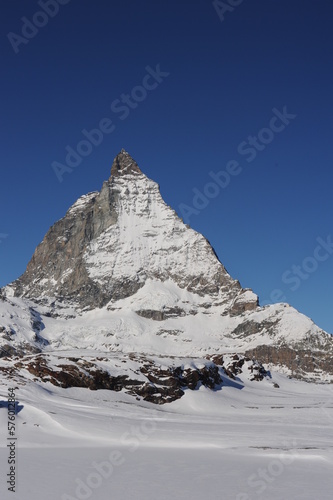Matterhorn mountain peak in Alps in winter with snow and clear blue sky in Cervinia, Italy and Zermatt, Switzerland. Beautiful and magnificent landscape on a sunny day in Europe