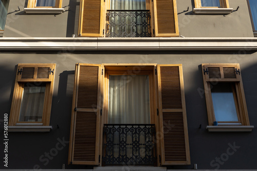 Part of the facade of the modern building. Windows with shutters.