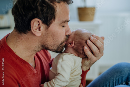 Close-up of father kissing his little son.