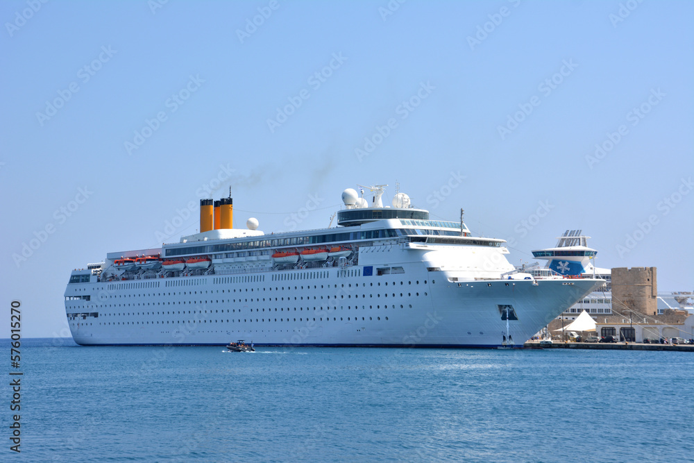 A cruise ship in a harbor with a boat isolated on the sea, close-up