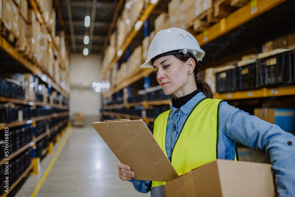 Warehouse female worker checking up stuff in a warehouse. Warehouse female worker checking up stuff in a warehouse.
