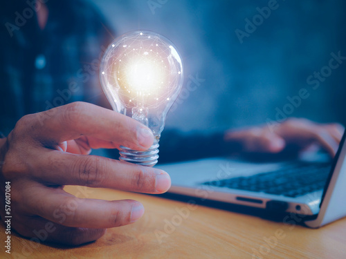 Concept of Ideas for presenting new ideas.Creative and inspiration.Innovative technology.Businessman holding light bulb and brain insideBusinessman holding light bulb and brain inside.