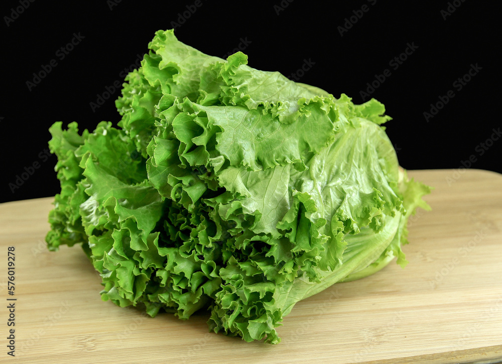 fresh lettuce on wooden cutting board