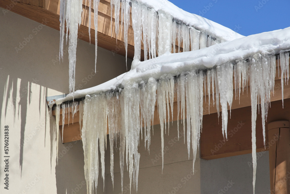 icicles and snow on a roof icicles and snow on a roof