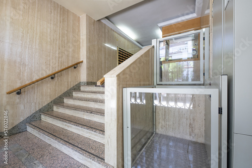 Portal of a residential building with granite stairs, marble walls and hydraulic elevator for people with mobility problems