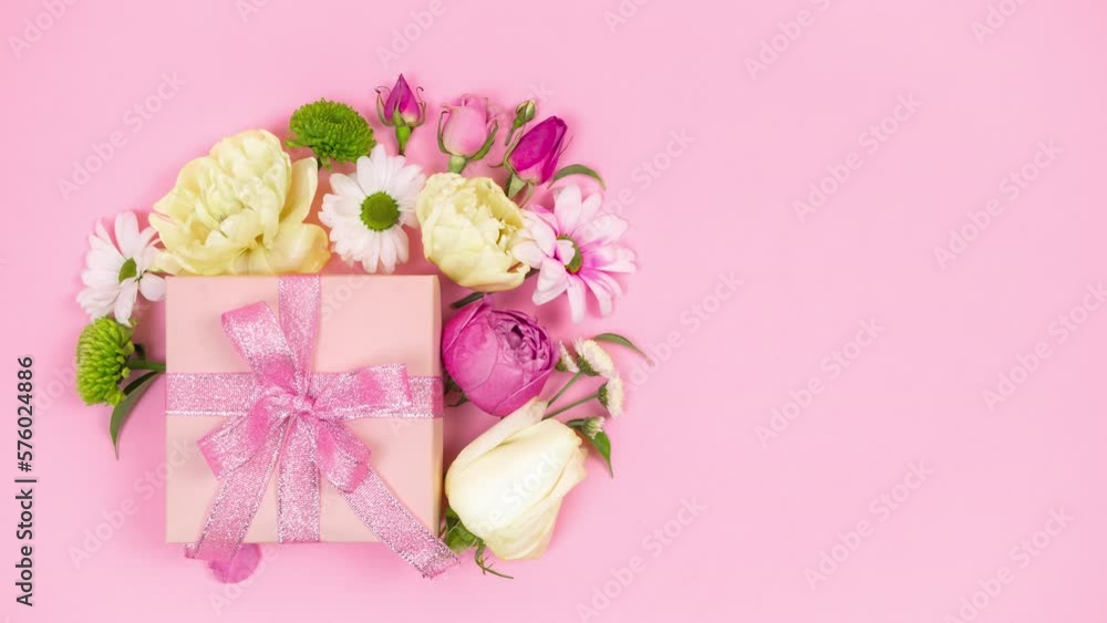 4k Happy mother's day, women's day, valentine's day or birthday holiday. Pastel pink background. Gift box beautifully decoreted natural flowers. Floral flat cards. Copy space. Stop motion animation. 4k Happy mother's day, women's day, valentine's day or birthday holiday. Pastel pink background. Gift box beautifully decoreted natural flowers. Floral flat cards. Copy space. Stop motion animation.