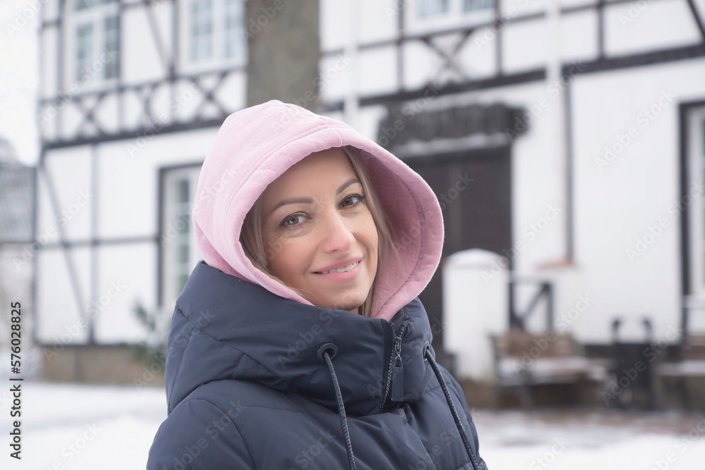 The girl enjoys the snow and drinks hot coffee. Winter fashion. The girl enjoys the snow and drinks hot coffee. Winter fashion.