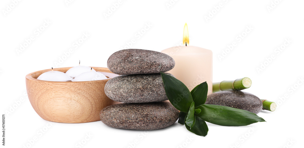 Spa stones, candles and bamboo on white background Spa stones, candles and bamboo on white background