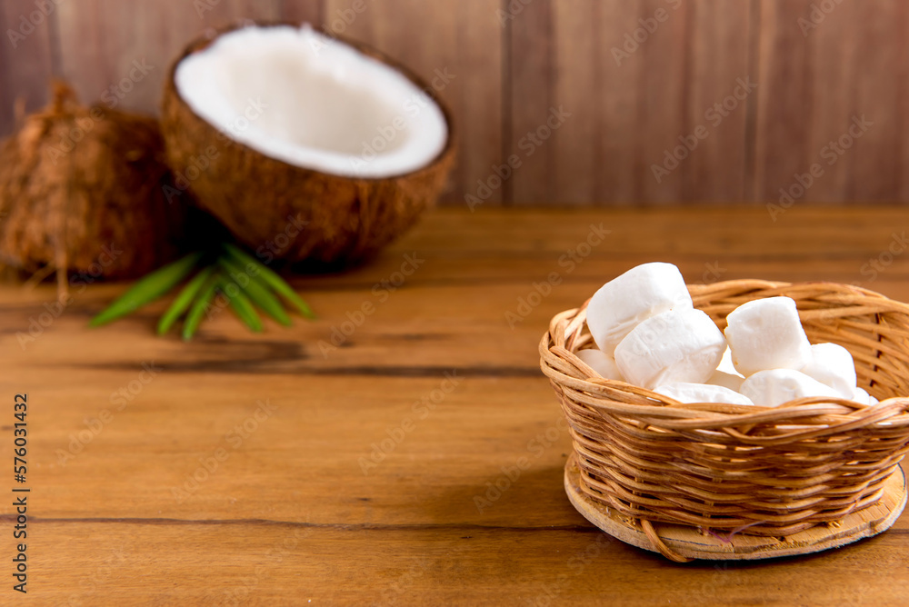 Coconut sweets on wooden table, coconut and coconut candies Coconut sweets on wooden table, coconut and coconut candies