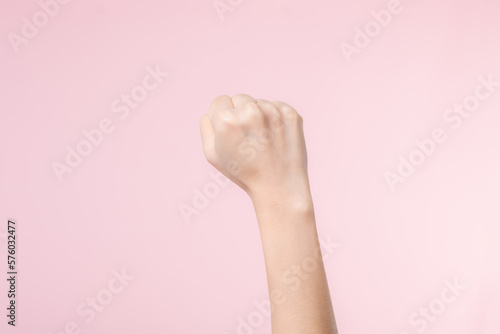 Woman fist fight for human rights and feminist with pink pastel background. Women empowerment  equality  strength and courage concept