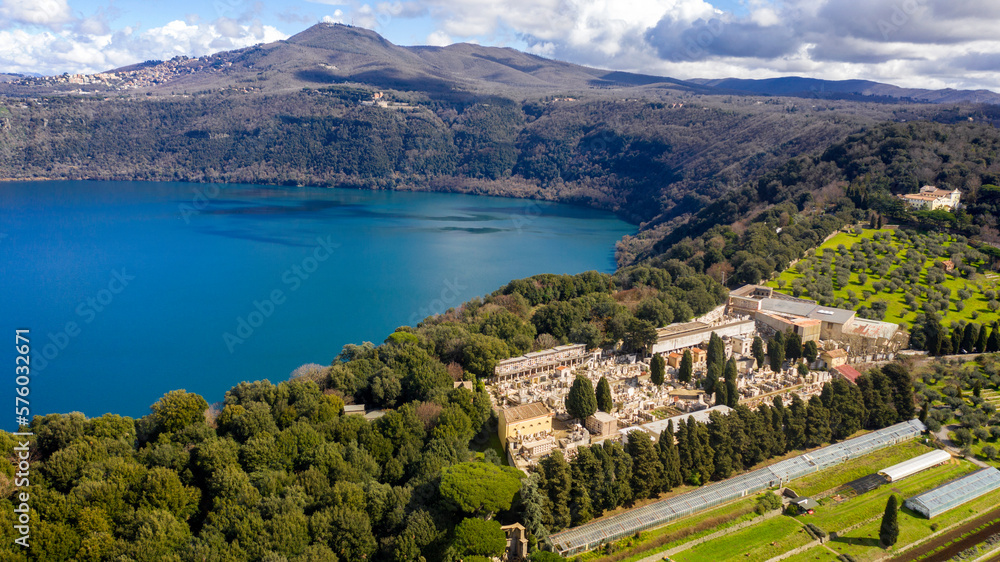 Aerial view of the cemetery in Albano Laziale, Italy. It is a small cemetery with the graves of the villagers. It is located in front of the Albano lake, a volcanic crater lake. 