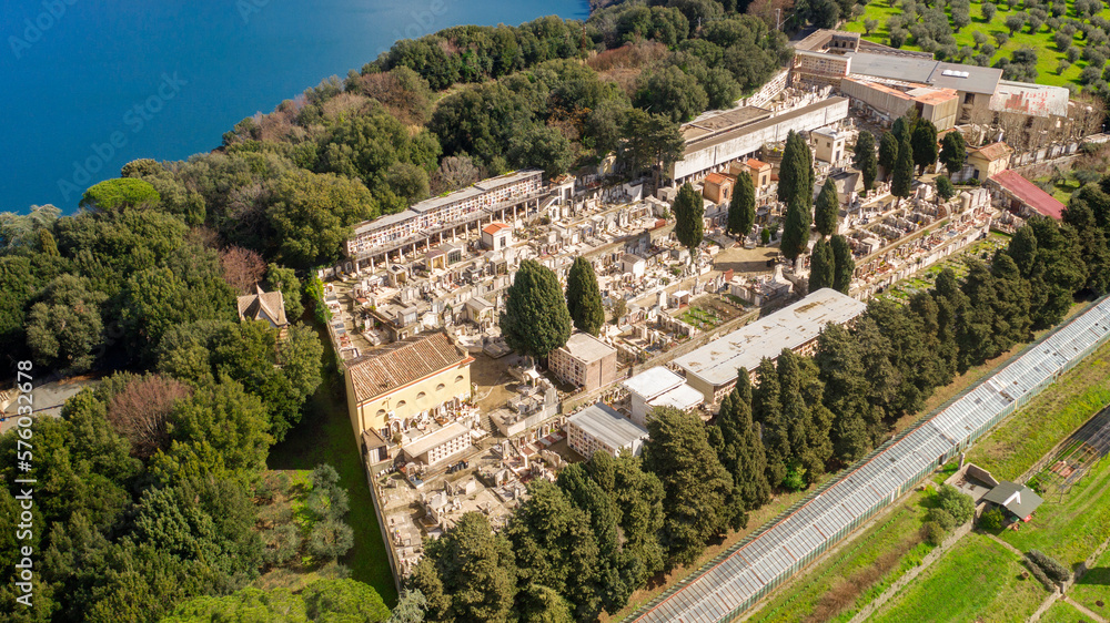 Aerial view of the cemetery in Albano Laziale, Italy. It is a small cemetery with the graves of the villagers. It is located in front of the Albano lake, a volcanic crater lake. 