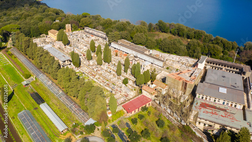 Aerial view of the cemetery in Albano Laziale, Italy. It is a small cemetery with the graves of the villagers. It is located in front of the Albano lake, a volcanic crater lake. 