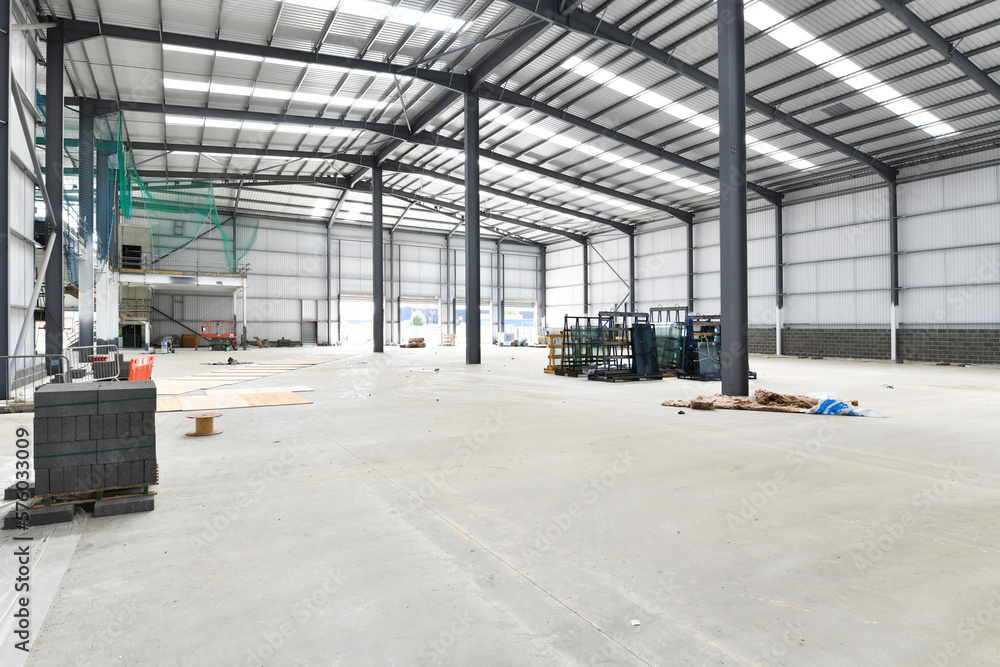 construction site of commercial warehouse building showing various materials and frame of building construction site of commercial warehouse building showing various materials and frame of building