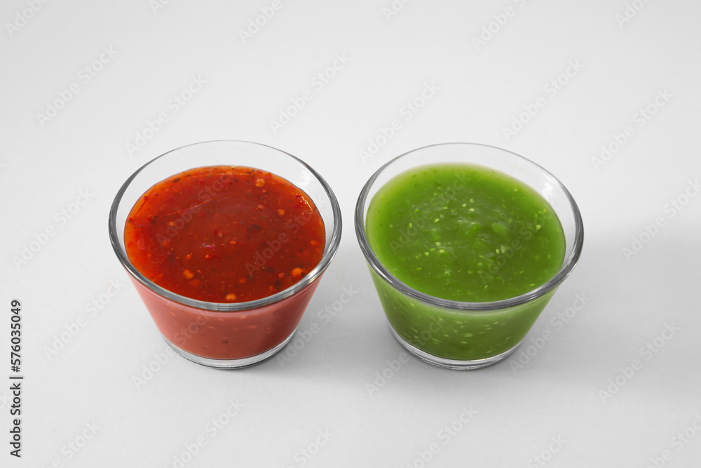 Bowls with delicious salsa sauces on white background Bowls with delicious salsa sauces on white background