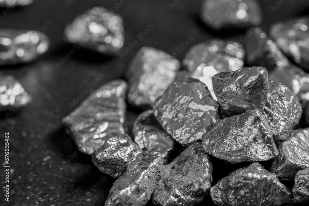 Pile of silver nuggets on black table, closeup Pile of silver nuggets on black table, closeup