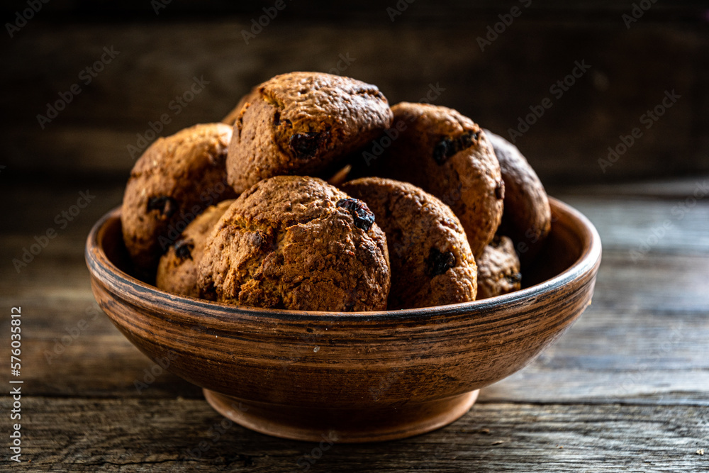 Homemade oatmeal cookies in a ceramic bowl on the kitchen table. Homemade oatmeal cookies in a ceramic bowl on the kitchen table.