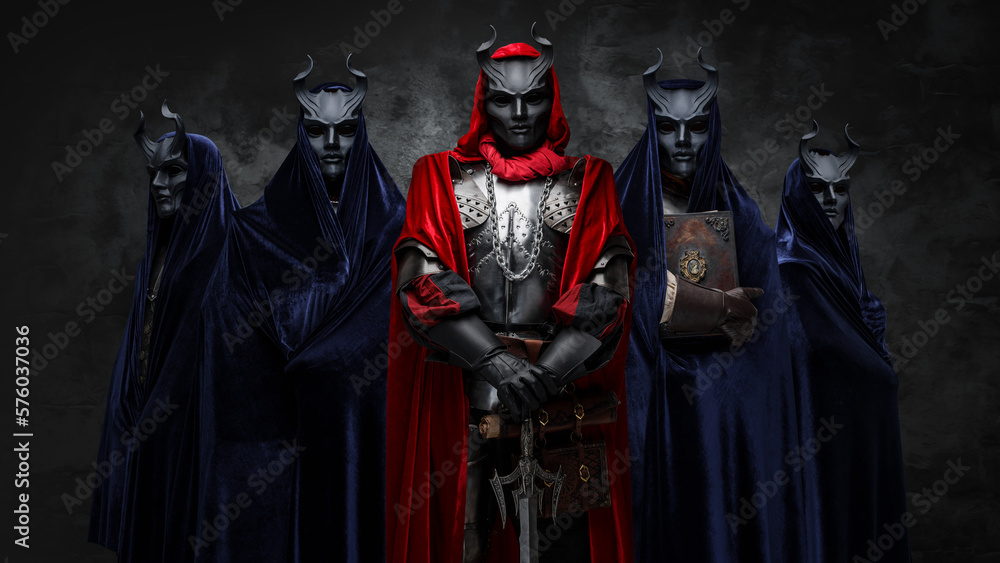 Shot of five brothers of mystic cult dressed in dark mantles and horned masks.