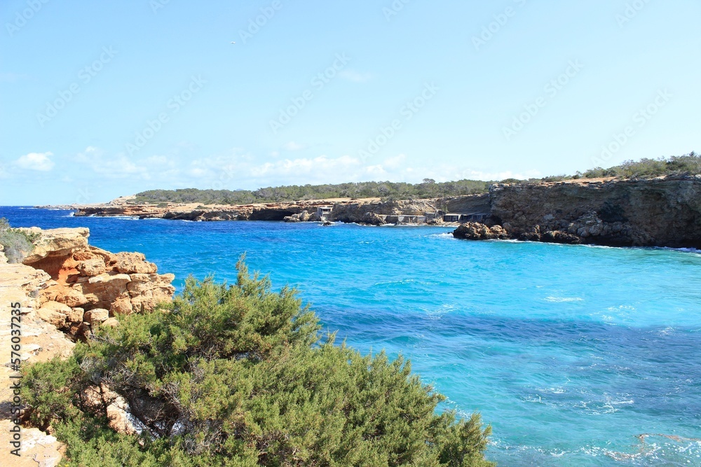 The paradisiacal beach of Cala Bassa in Ibiza in the Balearic Islands. Fantastic blue and turquoise sea and white sand beaches.