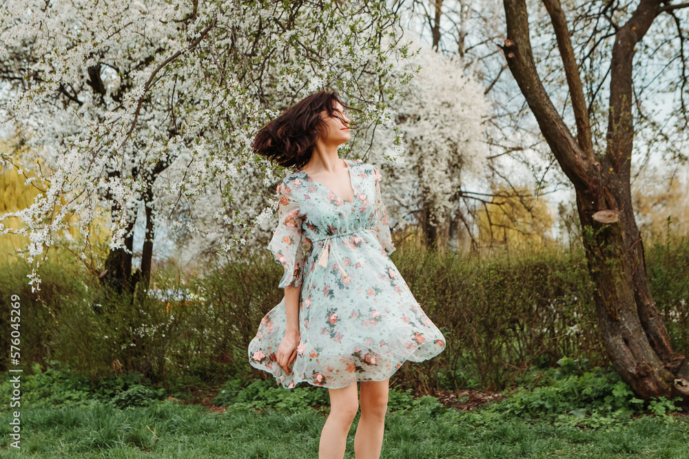 Portrait of charming pretty woman dressed flowery dress spinning around having fun laughing smiling near apple cherry tree blossoms blooming flowers in the garden park in early spring nature
Portrait of charming pretty woman dressed flowery dress spinning around having fun laughing smiling near apple cherry tree blossoms blooming flowers in the garden park in early spring nature