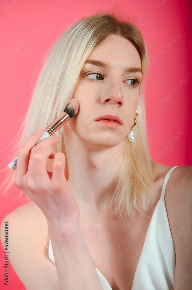 transgender posing isolated in studio. portrait of male model wearing make-up.