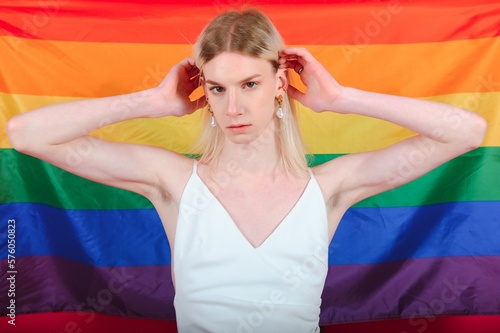 Young transgender woman on red background. photo