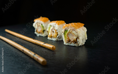 close up of 3 pieces of sushi. japanese food on a black background