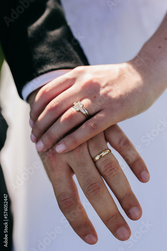 closeup of bride's and groom's hands with rings